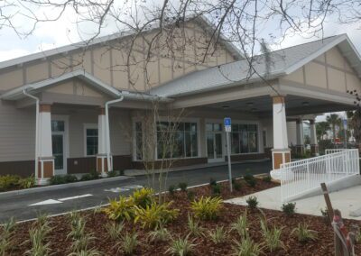 The front of a building with trees and plants.
