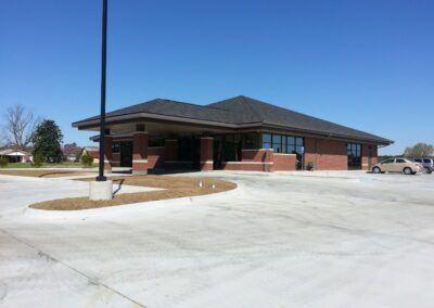 A brick building with a car parked in front of it.
