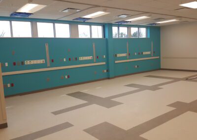 An empty room with blue walls and tile floors.