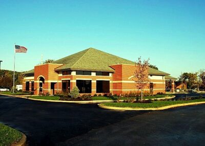 A brick building with an american flag in front of it.