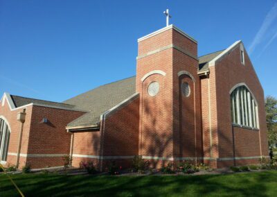 A brick church with a blue sky.