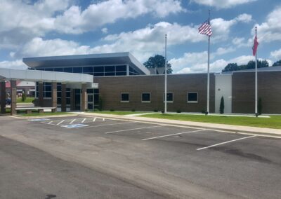 The front of a building with a flag flying over it.