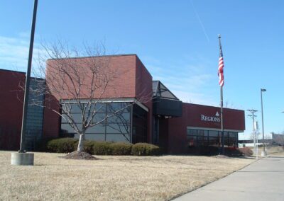 A red brick building with an american flag.