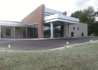 The front of a building with a grassy area in front of it.