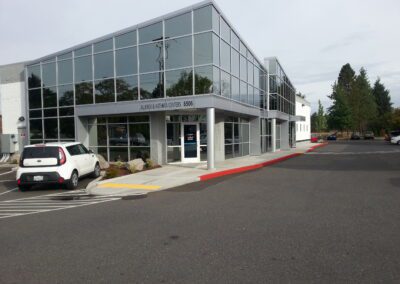 A building with cars parked in front of it.